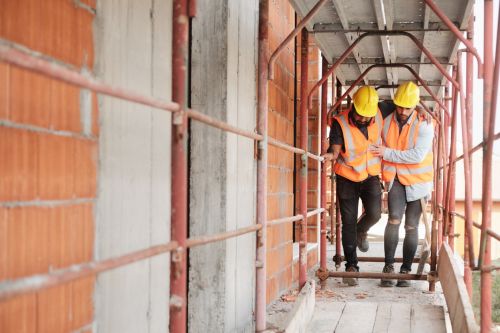 Construction Worker Helping Injured coworker at Construction Site