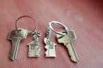 Two key rings, each with half of a house split down the middle